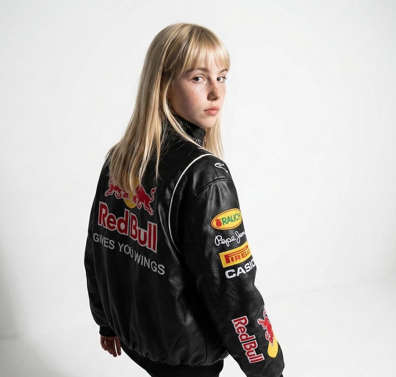 May include: Black leather jacket with Red Bull logos and patches. The jacket has white piping and the text "Gives You Wings" on the back. Patches include "RAUCH", "Pepe Jeans", "IRELLI", and "CASIO".