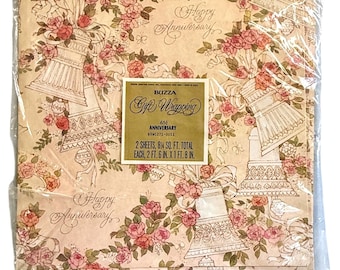 May include: Gift wrapping paper with a floral and bell design. The paper has a beige background with pink roses and bell illustrations. Text on the label reads "Happy Anniversary" and "Gift Wrapping". Each sheet measures 2 ft. 6 in. x 1 ft. 8 in.