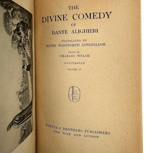 May include: A white ceramic mug with a black handle and the text "But First, Coffee" in a bold, black font. The mug is set against a blurred background. The mug appears to be approximately 10 cm tall.