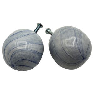 May include: A set of three ceramic nesting bowls in shades of blue, green, and white. The bowls have a speckled glaze and a simple, modern design. The largest bowl is about 15 cm in diameter.