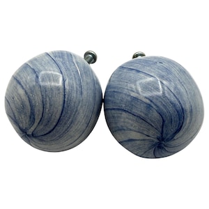 May include: A trio of ceramic mugs with a speckled, matte finish in cream, light grey, and dark grey. The mugs have a simple, minimalist design, ideal for tea or coffee.