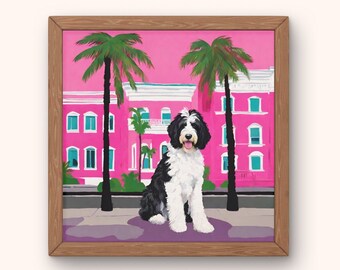 May include: A framed illustration of a black and white dog sitting in front of a pink building with palm trees. The building has white trim and windows.