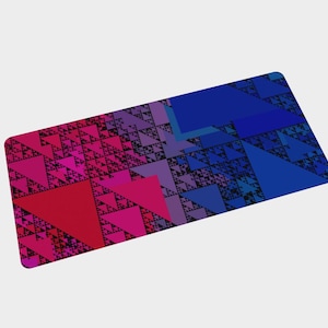 May include: A rectangular mat with a geometric design. The mat features a gradient of colors, transitioning from red and pink on the left to blue on the right. The design is composed of triangles.