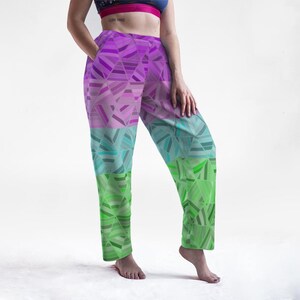 May include: Colorful geometric print pants in shades of purple, teal, and green. The pants feature a unique abstract design with a high waist and a relaxed fit. These pants are a stylish addition to any wardrobe.