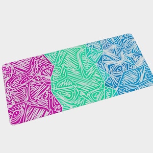 May include: A rectangular mousepad with a colorful abstract design. The design is divided into three sections: magenta, green, and blue. Each section features white scribbled lines creating a unique pattern. The mousepad is a vibrant accessory for any desk.