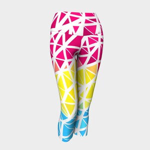May include: White leggings with a geometric pattern in shades of pink, yellow, blue, and green.