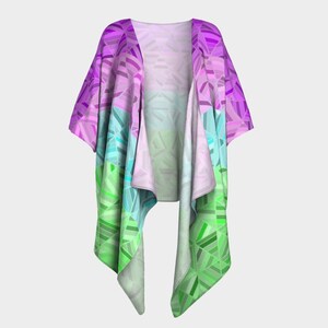 May include: A colorful, open-front kimono-style garment. The design features a geometric pattern in shades of purple, pink, blue, and green. The fabric appears lightweight and flowing, suitable for layering. The garment is displayed against a plain background.