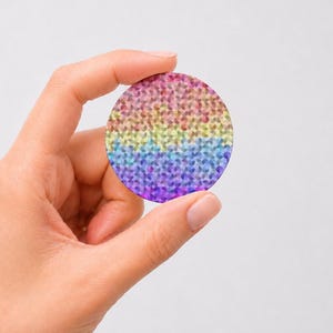 May include: A circular sticker featuring a vibrant rainbow gradient composed of small, repeating geometric semi-circle patterns. The design transitions smoothly from warm red and orange tones at the top to cool blue and purple hues at the bottom.