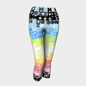 May include: Colourful geometric patterned leggings with a black waistband. The leggings have a rainbow colour scheme with circles and squares.