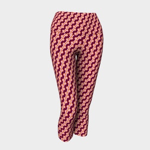 May include: Burgundy cropped leggings with a geometric pattern of orange and white swirls.