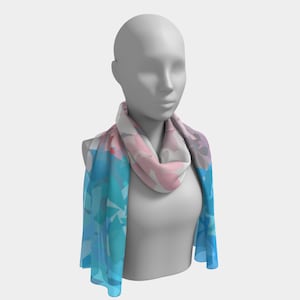 May include: A blue and pink patterned scarf with abstract shapes. The scarf is draped around a mannequin's neck.