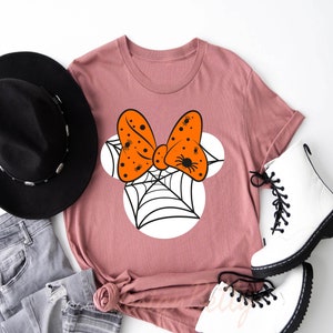 a t - shirt with a bow tie and a hat on top of it