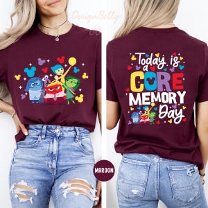 May include: Maroon t-shirt with a graphic of the characters from the movie Inside Out, including Joy, Sadness, Anger, Disgust, and Fear. The back of the shirt says "Today is a CORE MEMORY Day" with a Mickey Mouse head in the word "CORE".