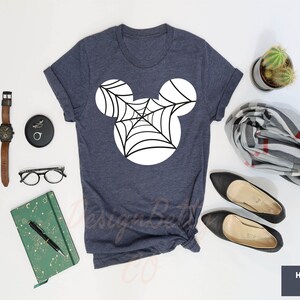 a t - shirt that has a spider web on it