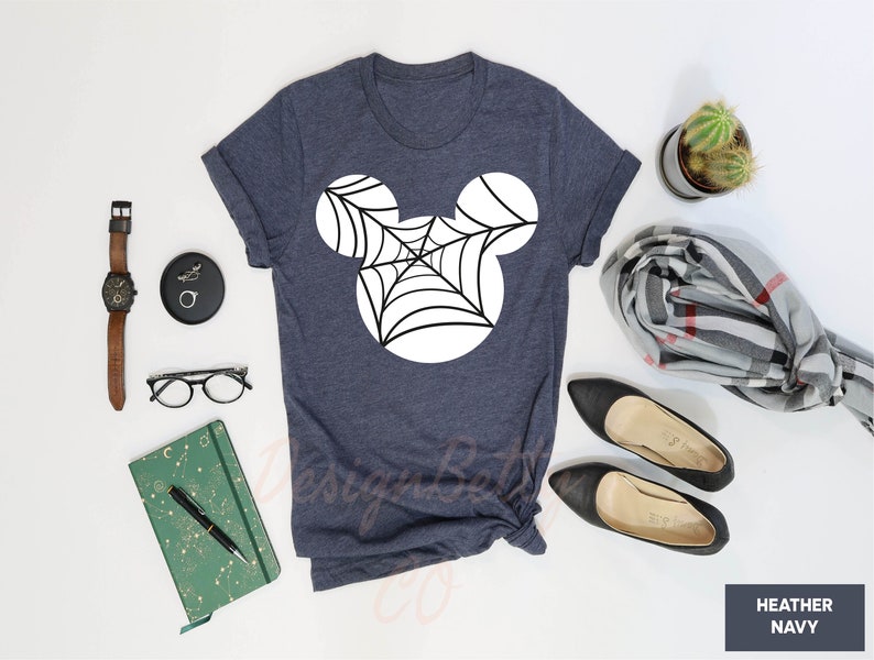 a t - shirt that has a spider web on it