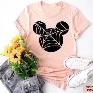 a pink shirt with a spider web on it