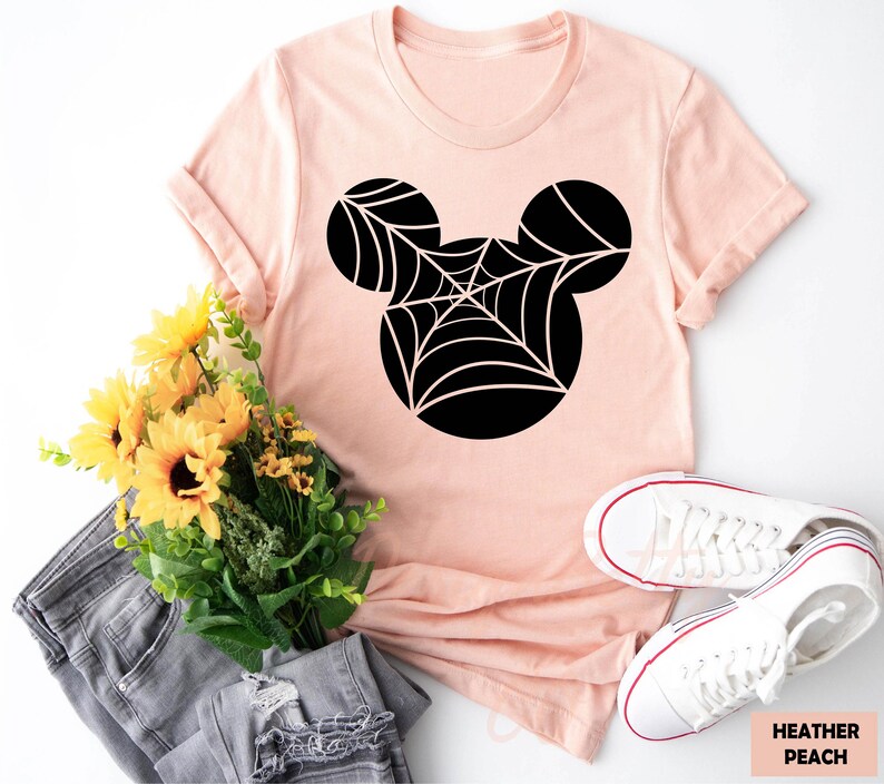 a pink shirt with a spider web on it