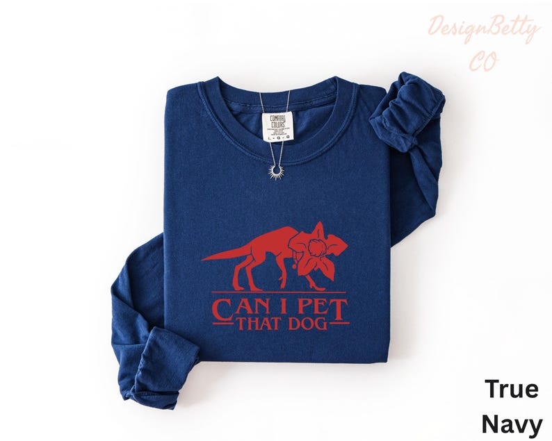 A navy blue long-sleeved t-shirt with a red graphic design and text printed on it.