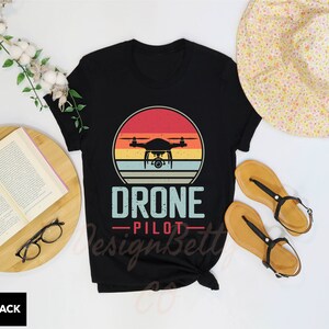 a t - shirt with a picture of a flying device on it