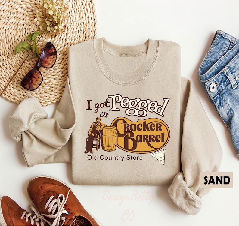 a sweater with the words, i got people at cracker barrel, and a