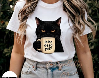 May include: White t-shirt with a black cat holding a coffee mug that says "Is he dead yet?"