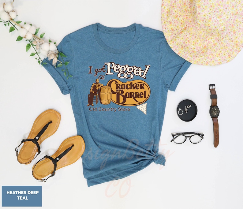 a t - shirt that says i'm pregnant and a hat, sunglasses,