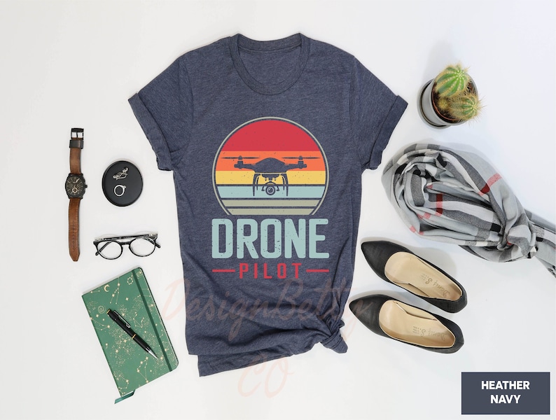 a shirt that says drone pilot next to a pair of shoes