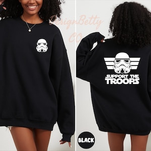 May include: Black sweatshirt with a white graphic of a Star Wars Stormtrooper on the front pocket and the text "Support the Troops" with a white graphic of a Stormtrooper on the back.