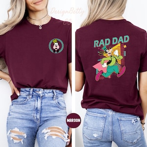 May include: Maroon t-shirt with a cartoon character on the front and the text "Rad Dad" and a cartoon character on the back.