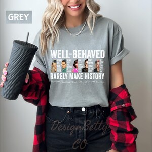 May include: Grey t-shirt with a white graphic print featuring portraits of famous women and the text "Well-behaved rarely make history". The text includes quotes from each woman.