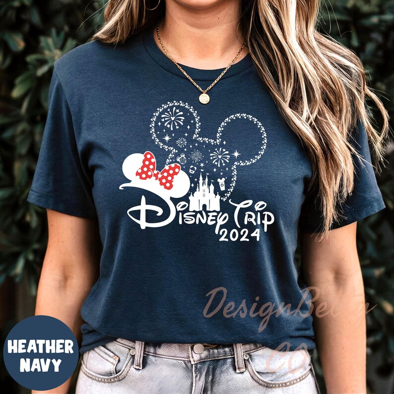 a woman wearing a disney trip shirt