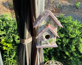 Broken china mosaic birdhouse done in pinks, purples, and greens