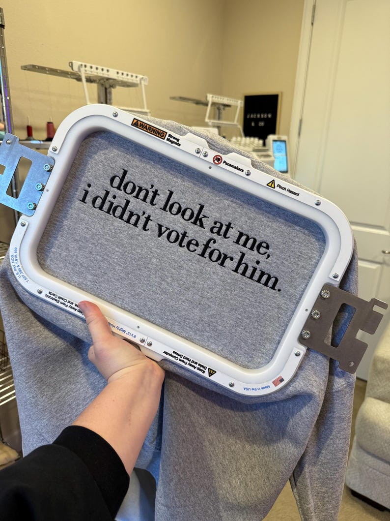 May include: A gray sweatshirt with the text "don't look at me, i didn't vote for him." embroidered on it.