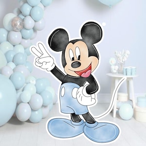 May include: A large, flat, die-cut cardboard cutout of Mickey Mouse standing and making a peace sign with one hand. The character features black ears, a tan face, a red mouth, white gloves, and light blue shorts and shoes with a black outline.