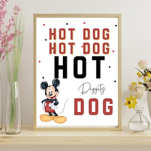 May include: Framed art print featuring Mickey Mouse and the words "HOT DOG" in red and black. The artwork includes a cartoon illustration of Mickey Mouse in his classic outfit. The print is displayed on a wooden shelf with vases of flowers.