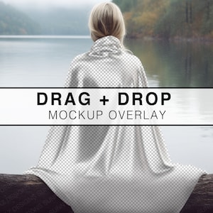 May include: A woman sits on a log by a lake, wrapped in a white blanket. The text "DRAG + DROP MOCKUP OVERLAY" is displayed on a black bar.