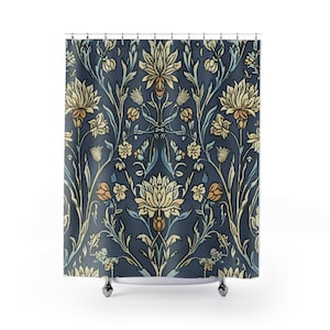 May include: A navy blue shower curtain with a floral pattern. The design features stylized flowers and foliage in shades of cream, light blue, and orange. The curtain hangs from a metal rod with silver-colored rings.