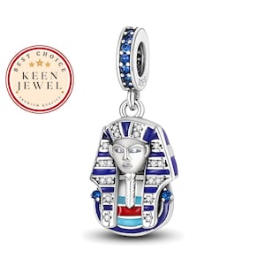 May include: Sterling silver charm featuring a blue and white enamel depiction of an Egyptian pharaoh's head with a crown. The charm has a blue and white enamel design with clear cubic zirconia stones.