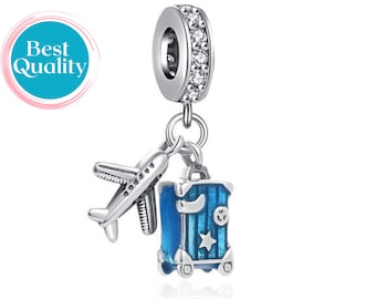 May include: Silver charm with a blue suitcase and airplane, perfect for travel lovers. The charm has a clear crystal ring.