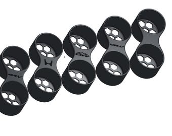 May include: Five black dual cup holder inserts with a honeycomb base pattern. Each unit features a figure-eight shape with two circular openings. Some units display the text CR-V with a mountain graphic, while others show a simple CR-V logo.