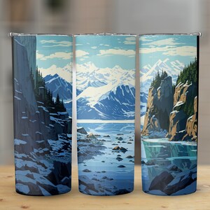 May include: Three stainless steel tumblers with a mountain scene design. The tumblers feature a snowy mountain range, a body of water, and a rocky cliff face. The scene is rendered in a blue, white, and gray color palette.