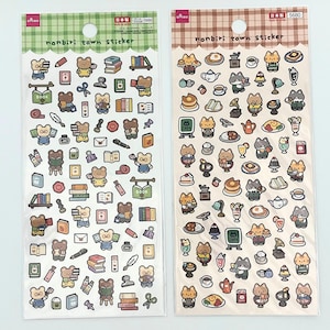May include: Two sticker sheets featuring cartoon bears and cats. One sheet has a green checkered border and the other has a brown checkered border. The stickers depict books, food, and other small objects. The text "nonbiri town sticker" is visible.