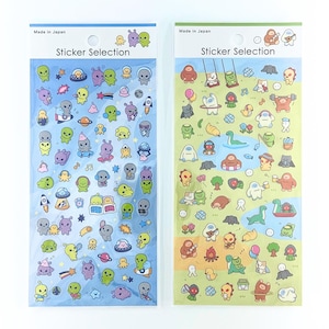 May include: Two rectangular sticker sheets labelled Sticker Selection and Made in Japan. The left sheet features various colourful alien characters and space-themed icons on a blue background. The right sheet displays mythical creatures and outdoor activities on a green background.