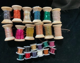 24 spools of wire. 12 on wooden spools that all different metallics and 12 on small plastic spools. preowned