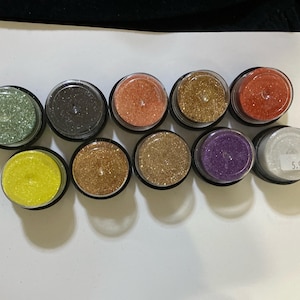 10 jars Art Glitter by Barbara Tromley .5 oz jar Ultrafine glitter. All still sealed except the crystal. Unused, see description for colors.