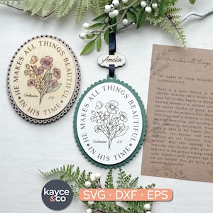 May include: Two wooden oval ornaments with floral designs and the text "He makes all things beautiful in His time." One ornament is light brown with pink flowers, the other is white with a green border.