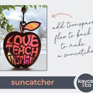 May include: A red apple-shaped wooden suncatcher with the words "Love Teach Inspire" cut out. The apple has a pink and orange stained glass effect.