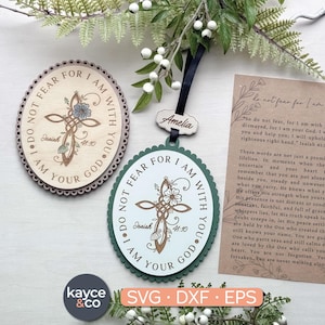 May include: Wooden cross-shaped ornaments with floral accents and the text "I do not fear for I am with you." One is oval with a scalloped edge, the other is round. A card with text and a small wooden tag are also visible.