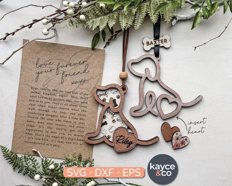 May include: A wooden ornament with a dog silhouette and the words "love furever friend xoxo" on a card. The ornament is brown and has a heart shape in the center. The text "insert heart" is written on the ornament. The ornament is labeled "Riley" and "Baxter".
