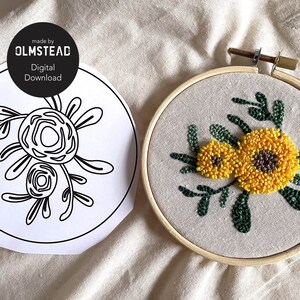 May include: A digital download pattern for a floral embroidery hoop art project. The pattern shows two stylized flowers with leaves. The finished embroidery project shows two yellow flowers with brown centers and green leaves in a wooden embroidery hoop.